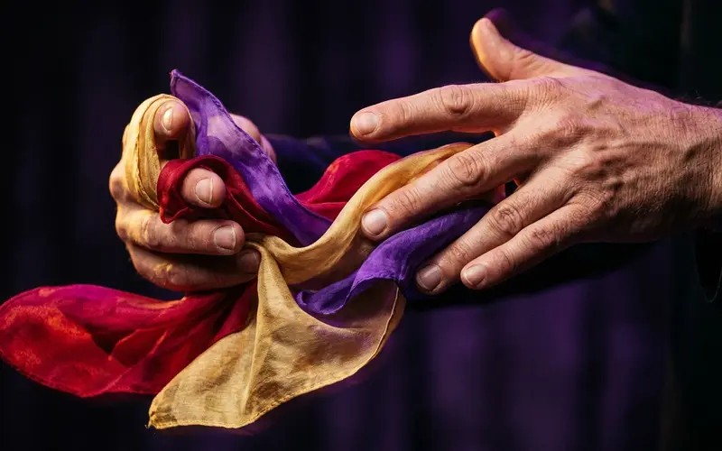 Hands performing a false shuffle with a deck of playing cards